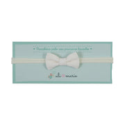 faixa de cabelo offwhite com laço de tecido bege claro sobre elástico macio e confortável