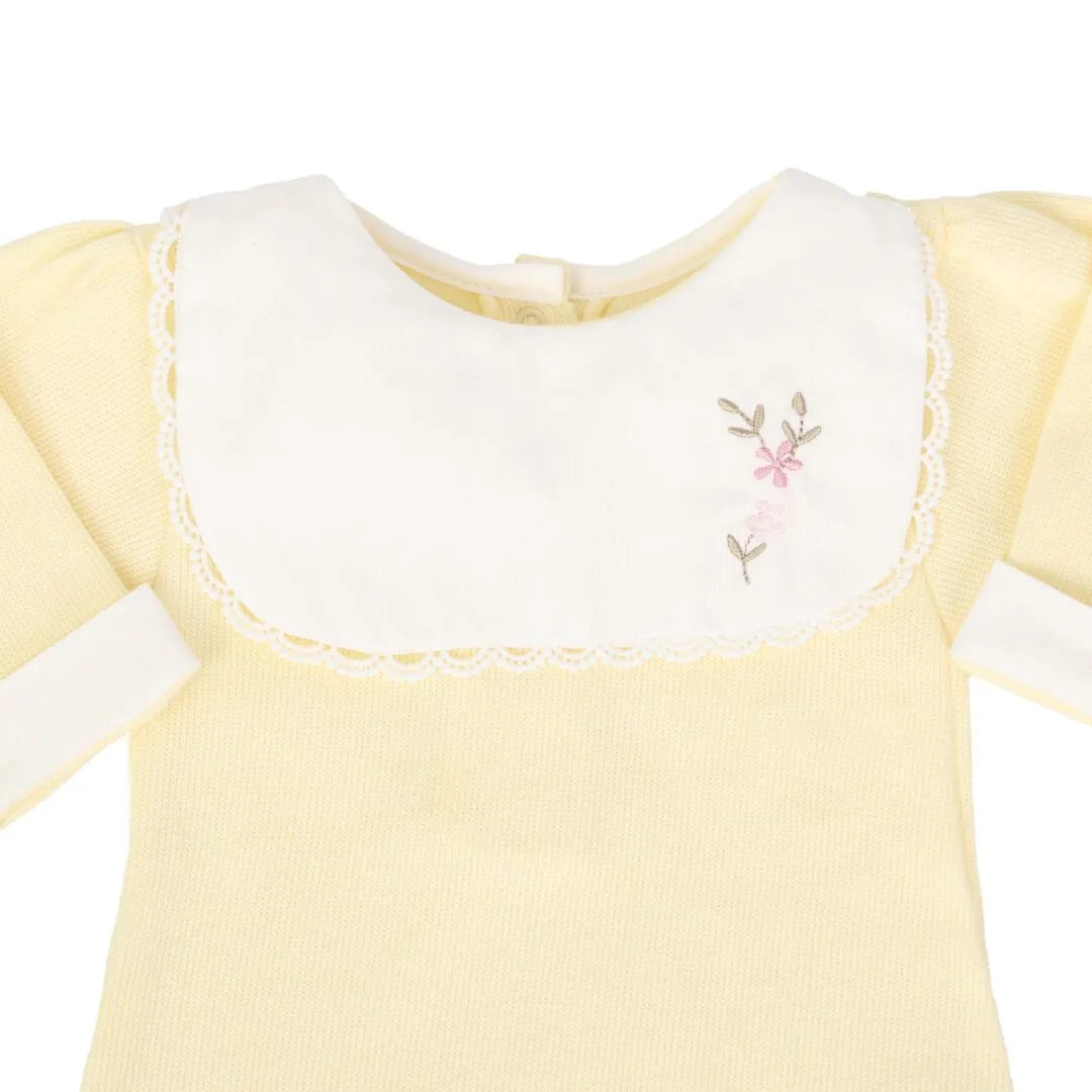 macacão carol amarelo bebê com pala branca bordada de flores rosa e acabamento delicado em renda nas bordas 