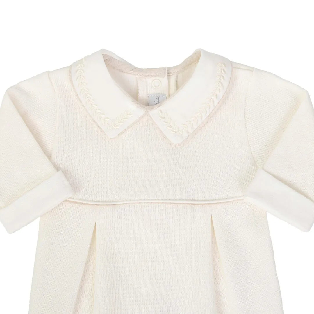 macacão clássico off-white com gola branca bordada em folhas e pregas frontais delicadas