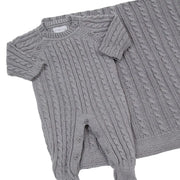 saída maternidade uli cinza composta por macacão em tricô com tranças delicadas e manta coordenada, ideal para o primeiro dia do bebê